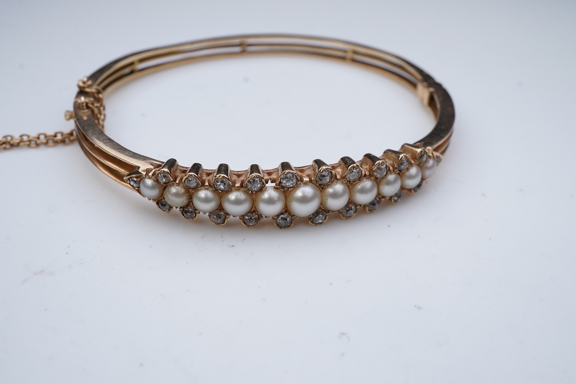 An Edwardian pearl and diamond bangle, early 20th century